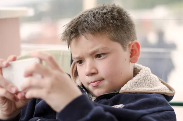 Boy kid child playing with mobile phone — Stock Photo, Image