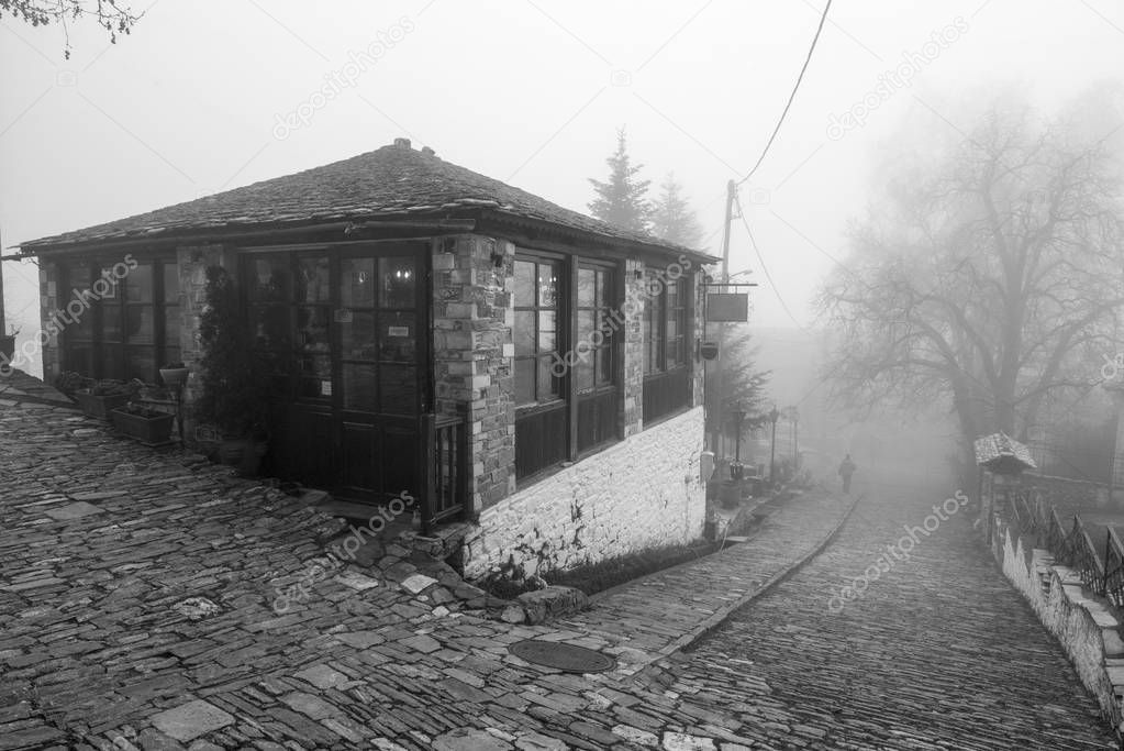 Fog and traditional stone building in Vizitsa village on mountain Pelion.Greece