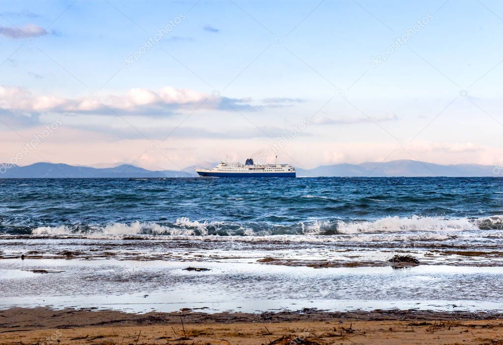 Large blue-white ferry ship leaving port of Rafina 