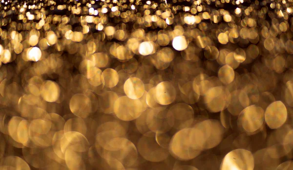 Pozadí zlatých třpytivých částic. Jiskřivé světlo. — Stock fotografie