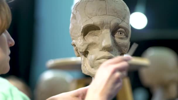 Sculptor at work. Woman working at the human head. — Stock Video