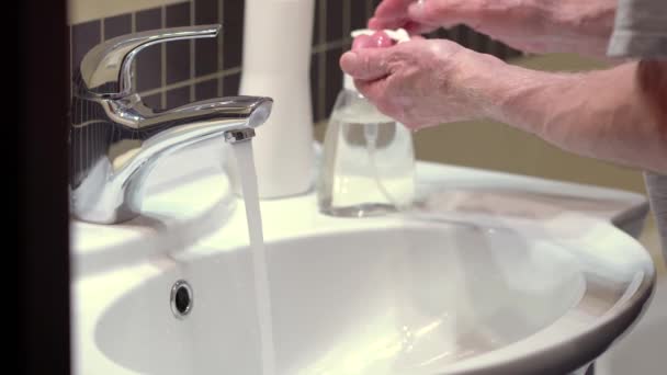 Concept of protecting the body from germs and viruses. Hand of old man that applying lather and soap — Stock Video