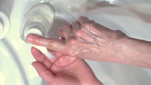 Concept of protecting the body from germs and viruses. Hand of woman that applying lather and soap — Stock Video