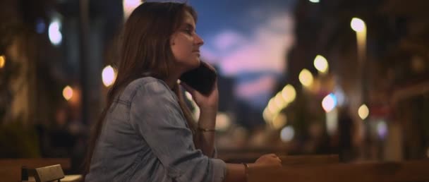 Young Woman Denim Shirt Talking Phone City Cafe Bokeh Lights — Stock Video