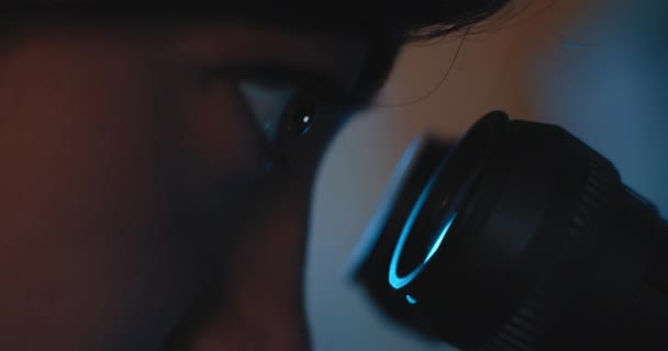 Extreme Close Female Research Scientist Eyes Looking Microscope Blue Lighting — Stock Video