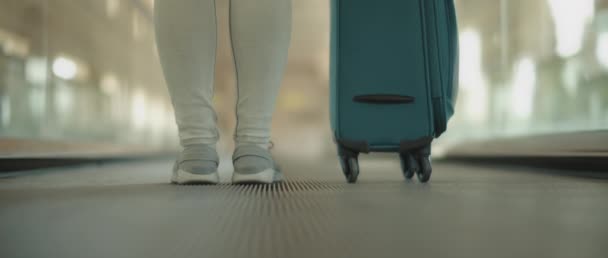 Woman Turquoise Suitcase Moving Walkway Escalator Airport Slow Motion Low — Stock Video