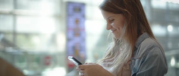 Woman Long Hair Denim Shirt Smiling While Texting Cellphone Slow — Stock Video