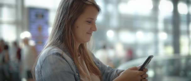 Woman Long Hair Denim Shirt Smiling While Scrolling Cellphone Slow — Stock Video