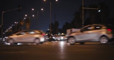 Night time lapse view of traffic on a busy city crossroad, down shot. Timelapse, shot with BMPCC 4K.  