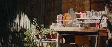 Güneşli bir yaz gününde eski bir klasik evin yanında bulaşık rafı ve saksılar, sinematik, yavaş çekim. Blackmagic Pocket Cinema Kamera 4k ile çekilmiştir.