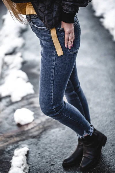 Knee figure of young beautiful blonde straight hair woman in the city, one hand in pocket - eyes closed - serenity, carefreeness concept - wearing jeans overalls and jacket — Stock Photo, Image