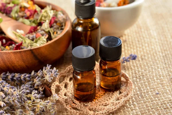 Essential oils with dried herbs Stock Picture