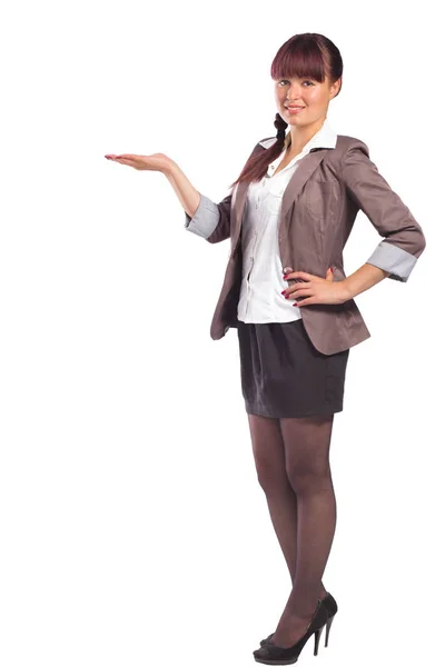 Full height portrait of attractive young woman showing something — Stock Photo, Image