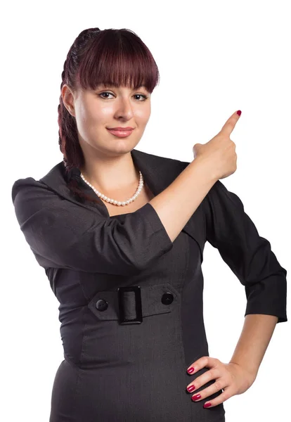 Jovem mulher atraente aponta o dedo para algo — Fotografia de Stock