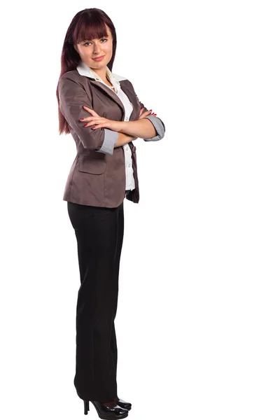Full length of young business woman standing with arms folded — Stock Photo, Image