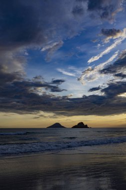 Gün batımında bir adası olan güzel Brezilya sahilleri senaryosu.