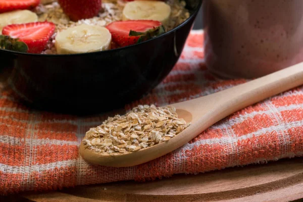 Wooden spoon with oatmeal — Stock Photo, Image