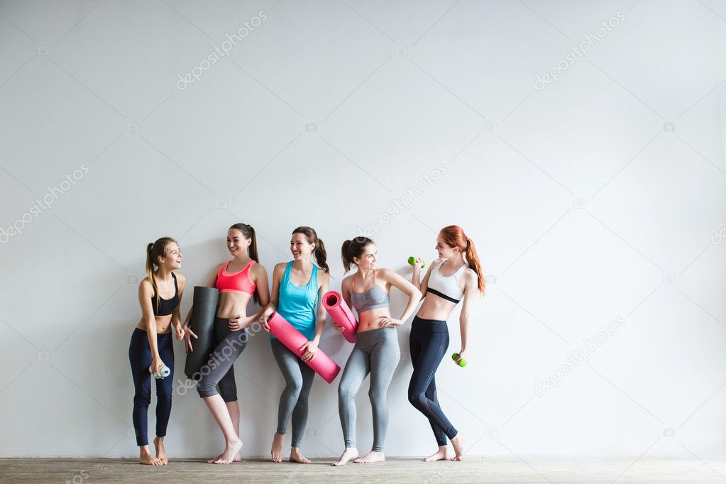 Smiling women in fitness studio.