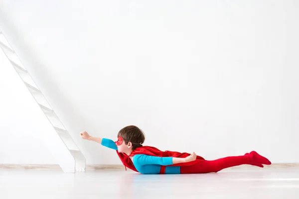 Criança vestida de Super-Homem em posição de voo . — Fotografia de Stock