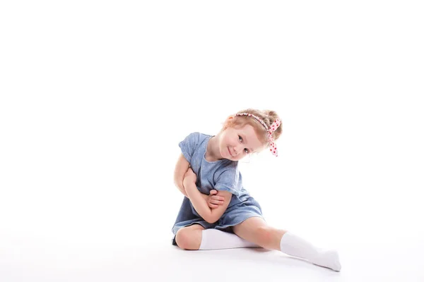 Closeup image of a pretty little girl sitting on the floor. — Stock Photo, Image