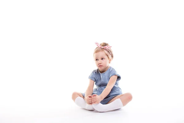 Little girl on a white. — Stock Photo, Image