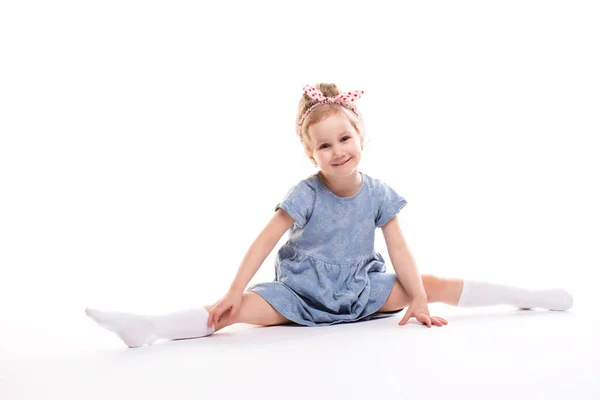 Smiling Little girl gymnast on a white. — Stock Photo, Image