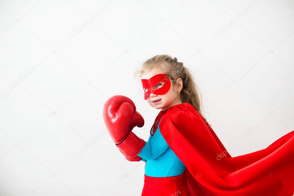 Superhero kid in boxing gloves Isolated on white background.