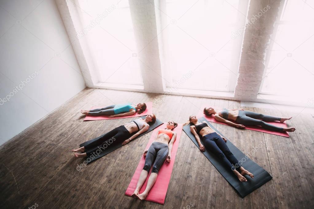 Group perfect figure women yoga relax after a workout. 