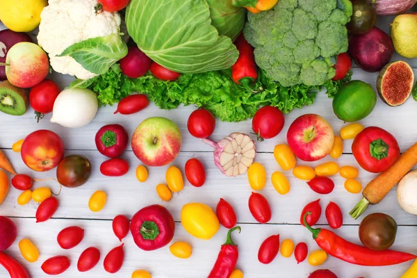 Diferentes vegetais e frutas em um fundo de madeira vista superior . — Fotografia de Stock