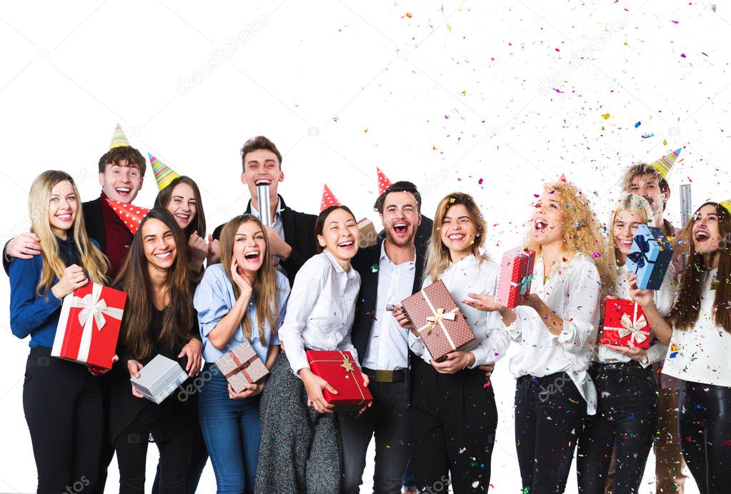 Group of attractive young friends standing over white background.