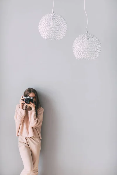 Portrait woman photographer covering her face with camera at home. — Stock Photo, Image