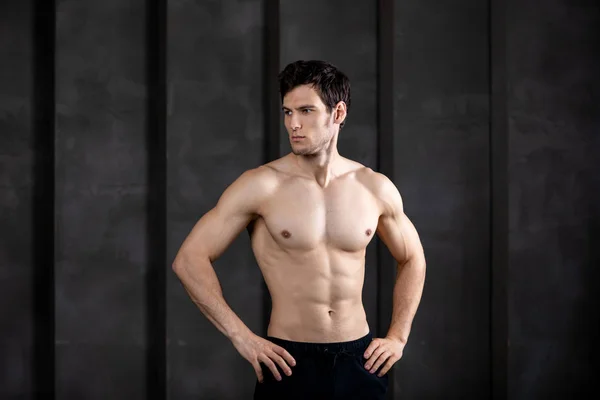 Portrait of muscular guy posing in a studio. — Stock Photo, Image