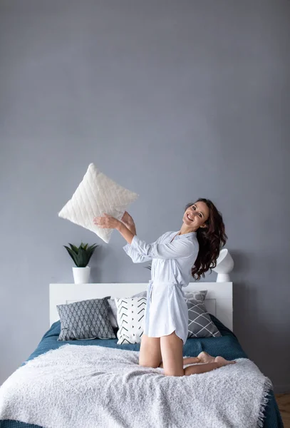 Fröhliche Frau Auf Dem Bett Die Kissen Wirft Spaß Wochenende — Stockfoto