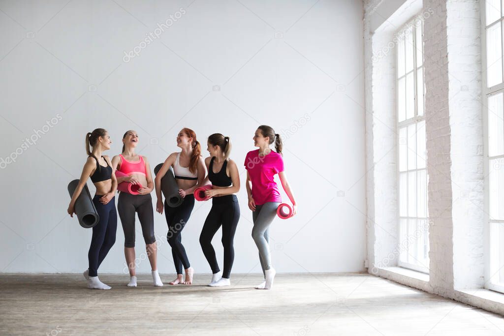 Happy group of fit women at the gym. Fitness, yoga, exercise.