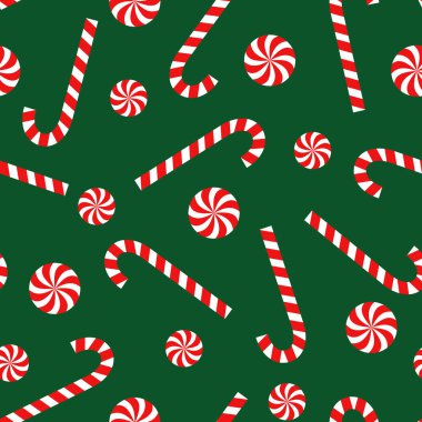 Şeker kamışı ve lolipop seamless Noel modeli yeşil zemin üzerine.