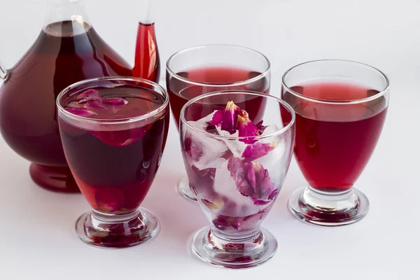 Fragrant red rose syrup (sherbet) in stylish glass pitcher and ice cubes made with red rose petals.Composed of ottoman style.Cold,sweet drink of Ramadan.
