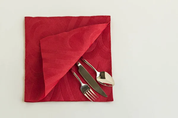 Elegant Cutlery Set in red color luxury paper napkin.Conceptual Image Of Christmas or New Year.