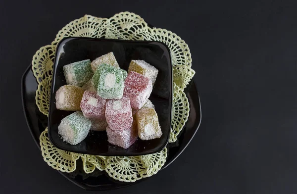 close-up shot of delicious Turkish delight or lokum on black tabletop