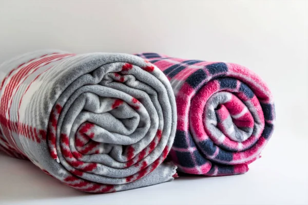 close-up shot of fleece plaid scarves on white surface