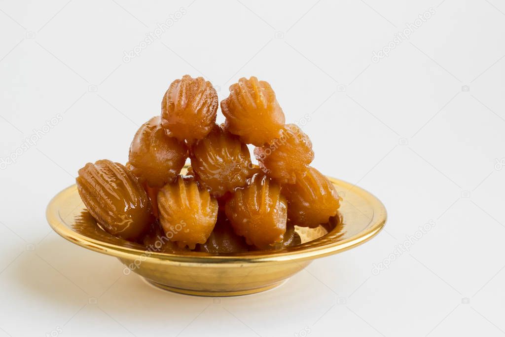 Traditional Turkish Crispy,Pastry Dessert,Tulumba designed in shiny metal bowl on white background with copy space