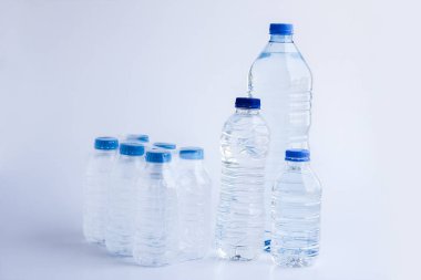 close-up shot of plastic bottles of water on white surface