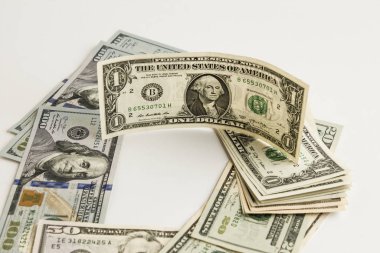 close-up shot of dollar bills on white surface