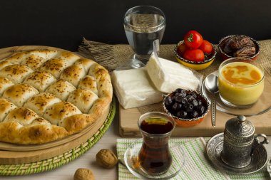 close-up shot of delicious Turkish Pide Bread with nuts, olives and dry dates on white surface clipart