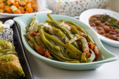 close-up shot of pea pods on Ramadan feast table with various dishes