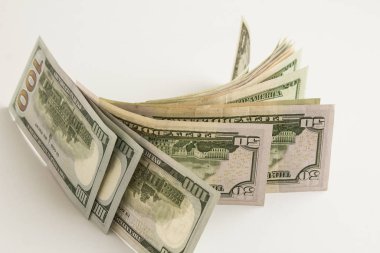 close-up shot of dollar bills on white surface