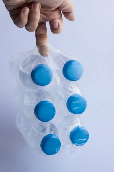 Close Shot Woman Holding Pack Plastic Bottles Water White Surface — 스톡 사진