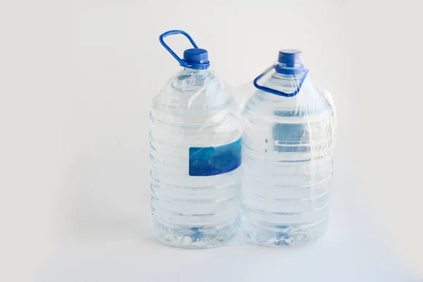 Close Shot Two Big Plastic Bottles Water White Surface — 스톡 사진