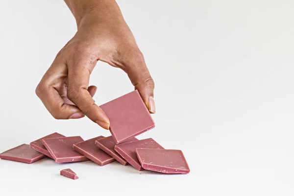 Fourth Type Chocolate Ruby Chocolate Sliced Hand Holding White Background – stockfoto