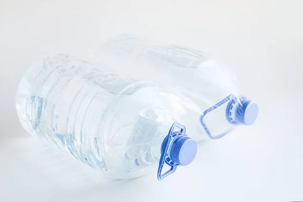 Close Shot Two Big Plastic Bottles Water White Surface — 스톡 사진