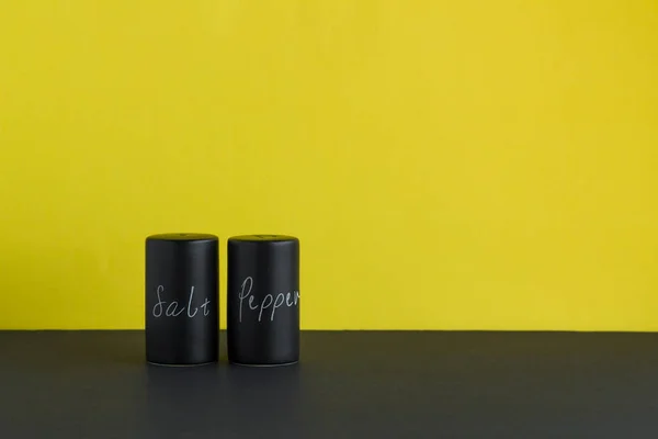 Salt Pepper Shakers Stand Black Ground Front Fluorescent Yellow Color — стоковое фото